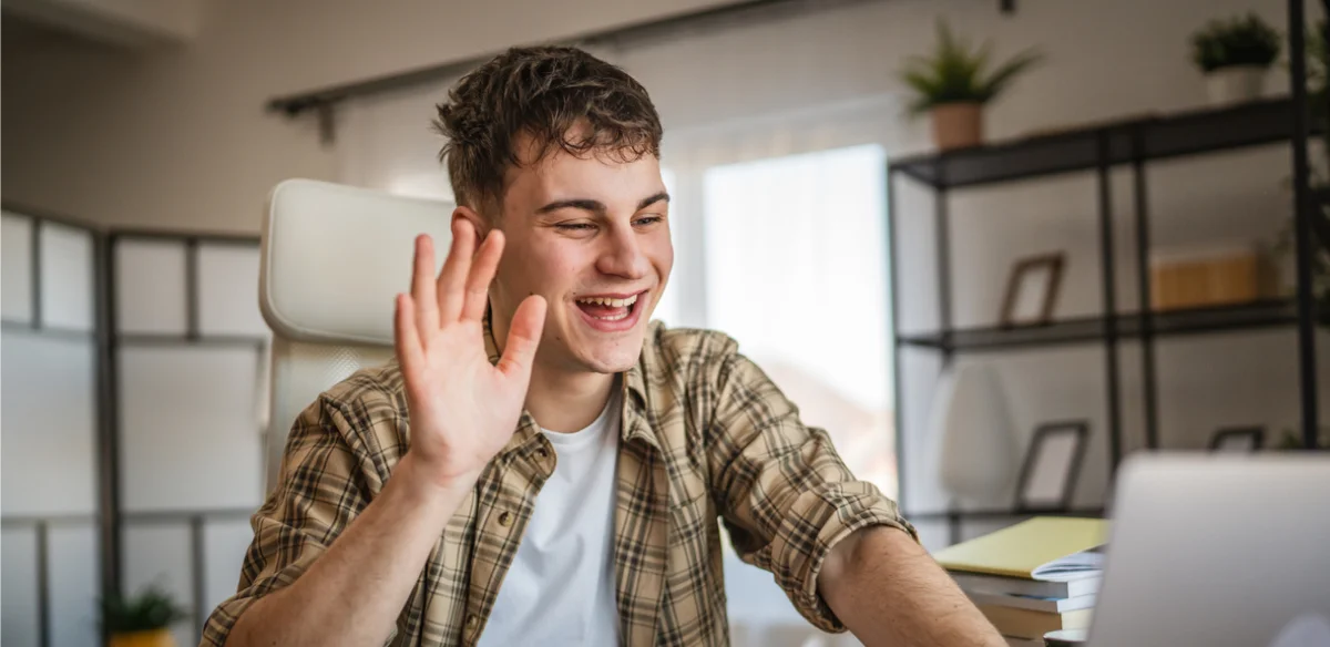 boy saying hi to virtual meeting